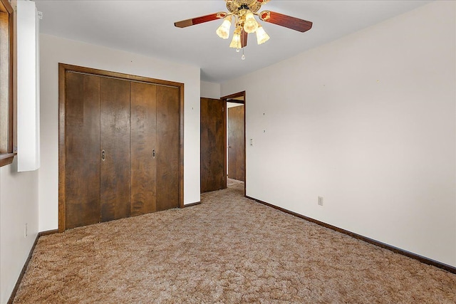 unfurnished bedroom with a closet, carpet flooring, and baseboards
