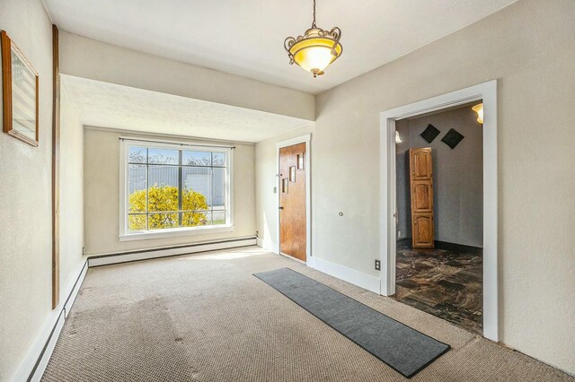 interior space featuring baseboards, a baseboard heating unit, carpet flooring, and a baseboard radiator