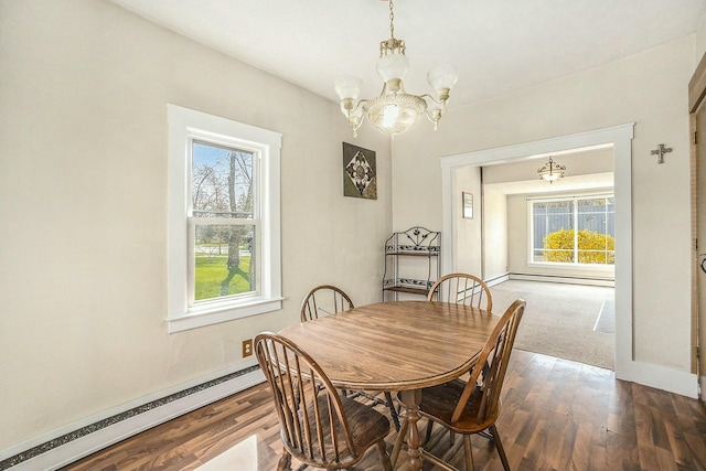 dining space featuring an inviting chandelier, baseboards, wood finished floors, and a baseboard radiator