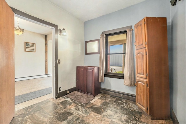 hallway with a baseboard radiator and baseboards