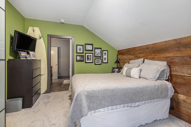 bedroom with carpet flooring, wood walls, and lofted ceiling