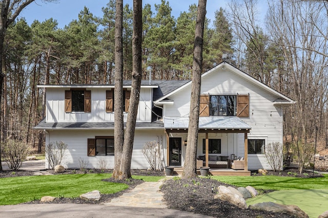 view of front of home with board and batten siding and a front lawn