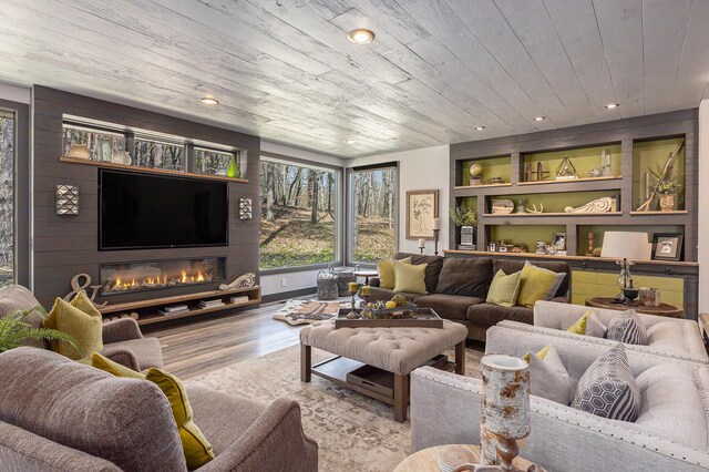 living area featuring wood finished floors, built in shelves, recessed lighting, and wooden ceiling