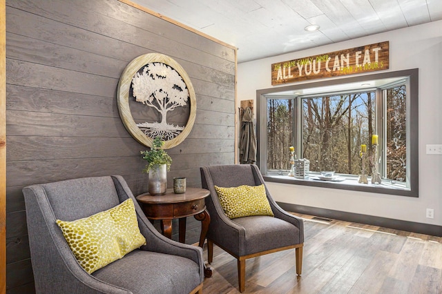 living area featuring wood walls, wood finished floors, recessed lighting, and visible vents
