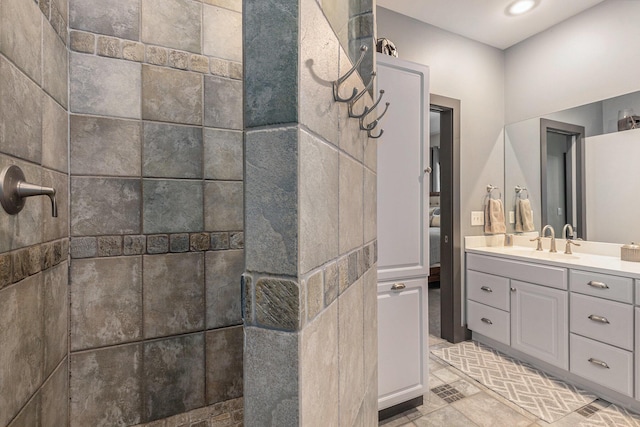 bathroom featuring a walk in shower and vanity