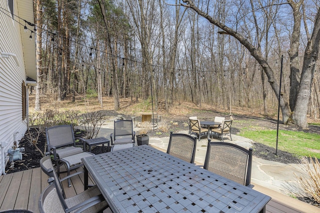 wooden deck with a patio and outdoor dining space