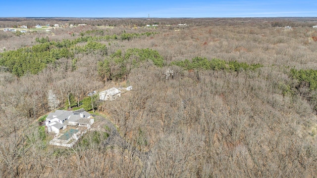 bird's eye view featuring a wooded view