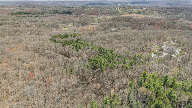 drone / aerial view featuring a forest view