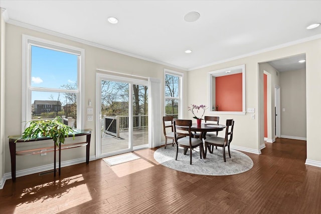 dining room with baseboards, ornamental molding, wood finished floors, and recessed lighting