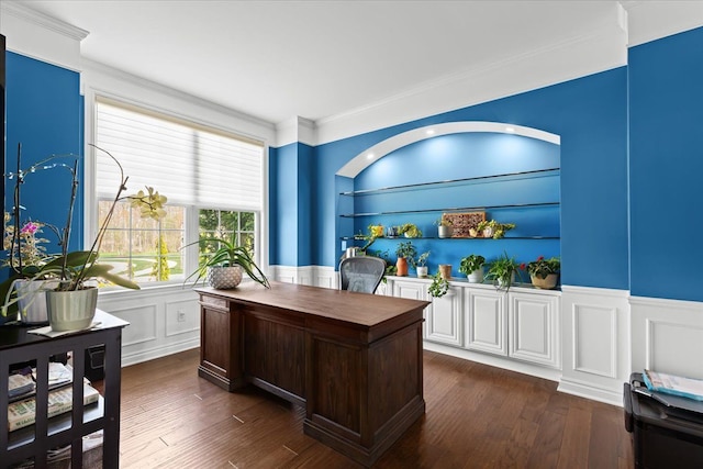 office space with crown molding, wainscoting, a decorative wall, and dark wood finished floors