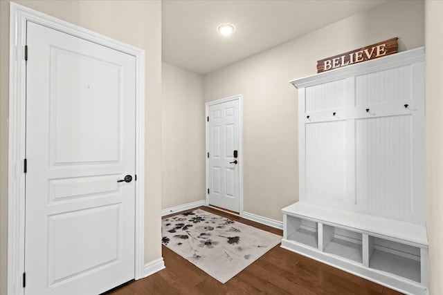 mudroom featuring baseboards and dark wood-style flooring