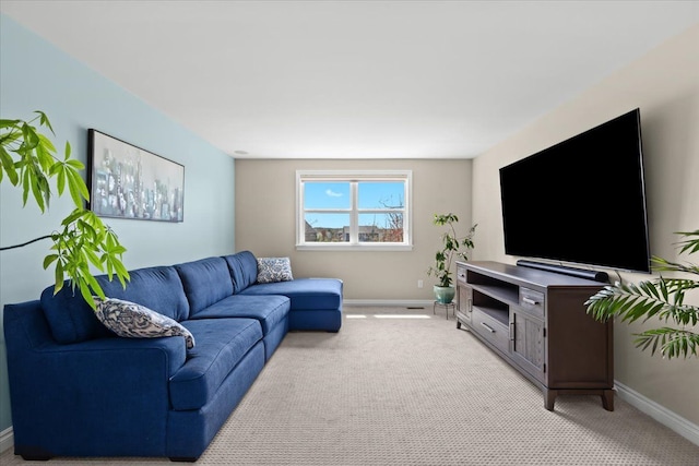 living room featuring baseboards and light colored carpet