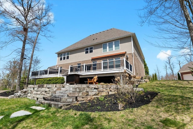 rear view of property with brick siding, a lawn, and a wooden deck