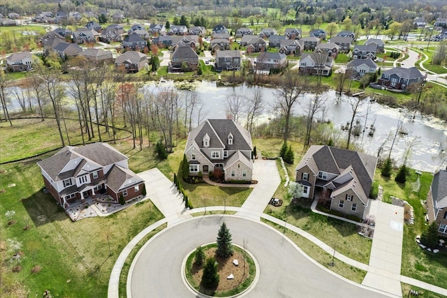 drone / aerial view with a water view and a residential view