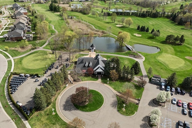 birds eye view of property with a water view and golf course view