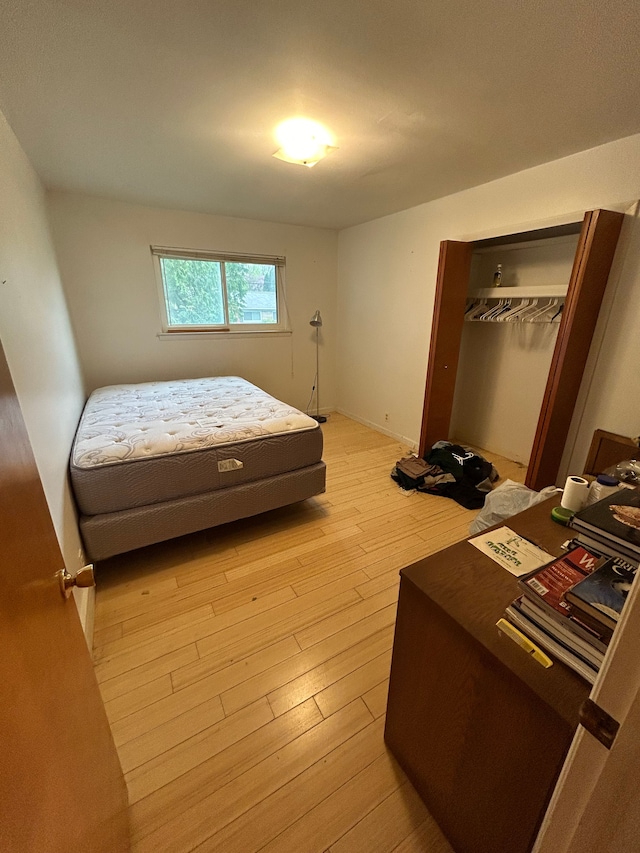 bedroom featuring a closet and light wood finished floors