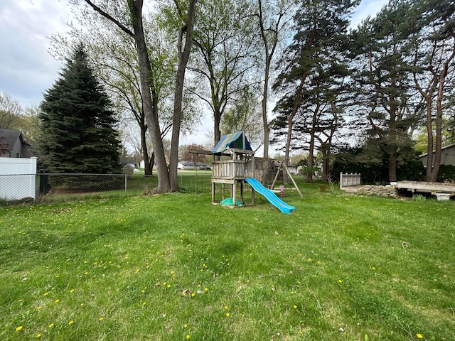view of yard featuring a playground and fence