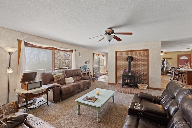 3620 Sharp Rd, Adrian, MI 49221 - living area with a wood stove, carpet, ceiling fan, and a textured ceiling