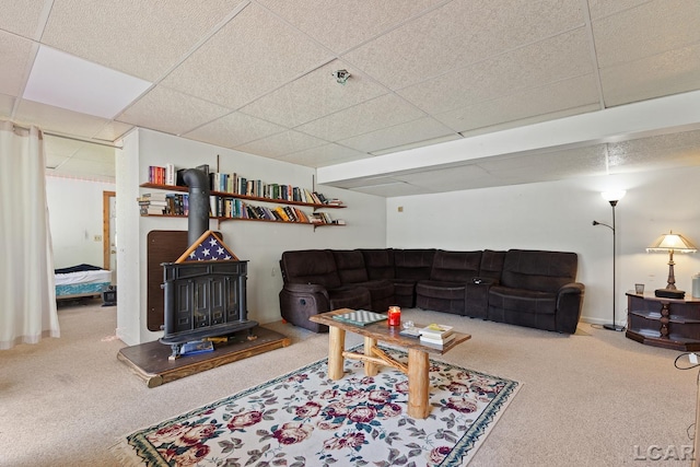 3620 Sharp Rd, Adrian, MI 49221 - living room featuring a drop ceiling, a wood stove, and carpet flooring