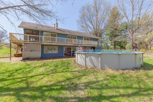 3620 Sharp Rd, Adrian, MI 49221 - back of house with a lawn, a wooden deck, and a chimney