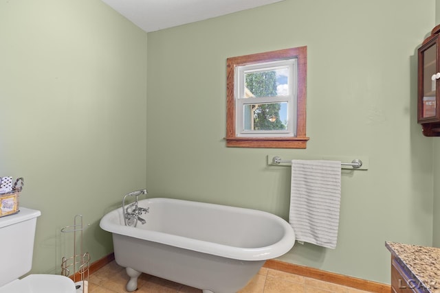 3620 Sharp Rd, Adrian, MI 49221 - bathroom featuring baseboards, tile patterned floors, toilet, and a soaking tub