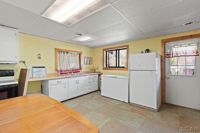 3620 Sharp Rd, Adrian, MI 49221 - kitchen featuring freestanding refrigerator, electric range, white cabinetry, a paneled ceiling, and white refrigerator