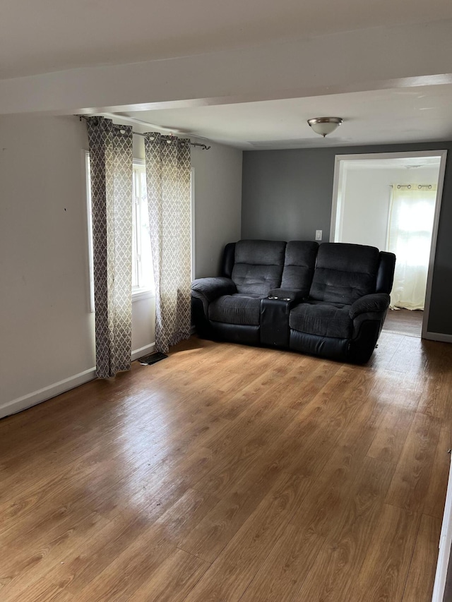 living room featuring baseboards and wood finished floors