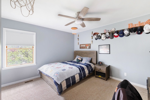 bedroom with baseboards, carpet, a ceiling fan, and visible vents