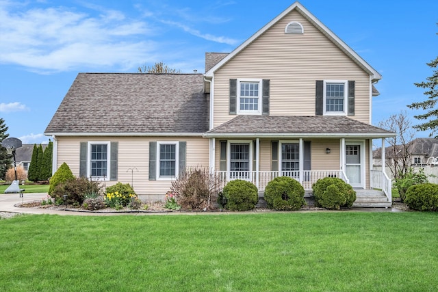 traditional home featuring a porch, a shingled roof, and a front yard