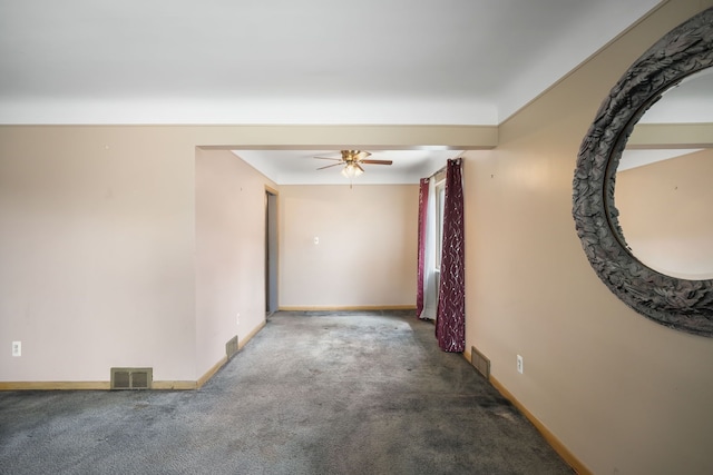 carpeted empty room with baseboards, a ceiling fan, and visible vents