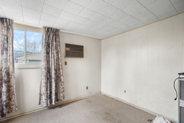 carpeted empty room featuring an AC wall unit