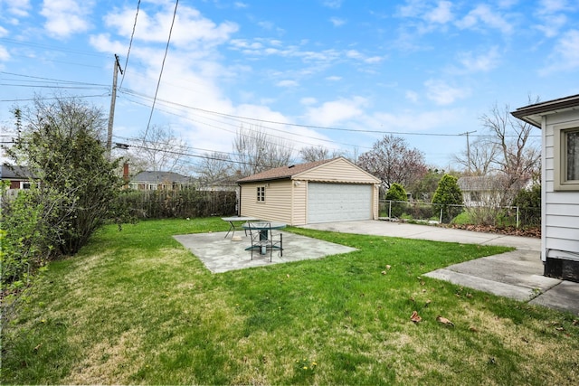 view of yard with a patio, an outbuilding, a fenced backyard, and a garage