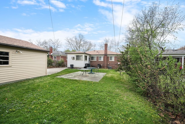 rear view of house featuring a patio and a yard