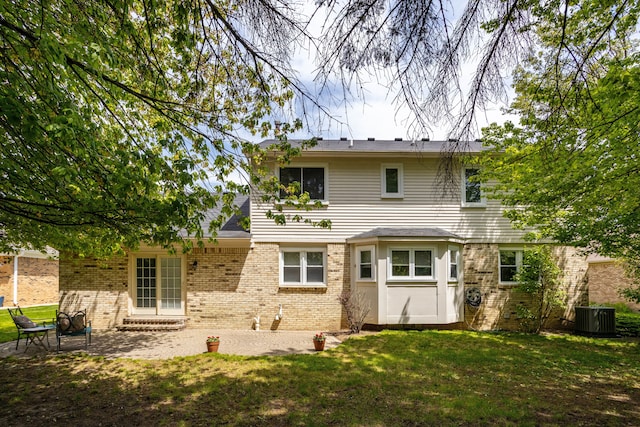 44492 Midway Dr, Novi, MI 48375 - back of house with brick siding, central air condition unit, and a yard