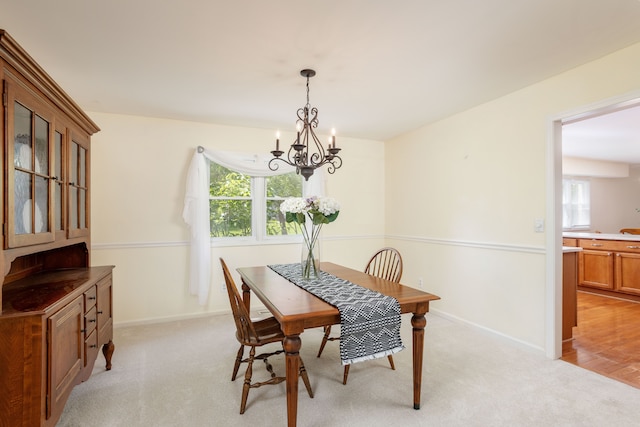 44492 Midway Dr, Novi, MI 48375 - dining area with a chandelier, healthy amount of natural light, light colored carpet, and baseboards