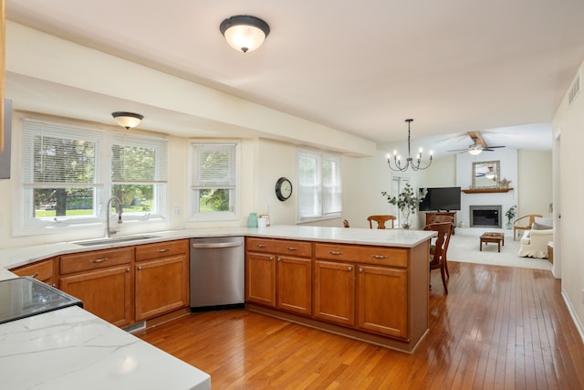 44492 Midway Dr, Novi, MI 48375 - kitchen featuring stainless steel dishwasher, a sink, a peninsula, light wood finished floors, and plenty of natural light