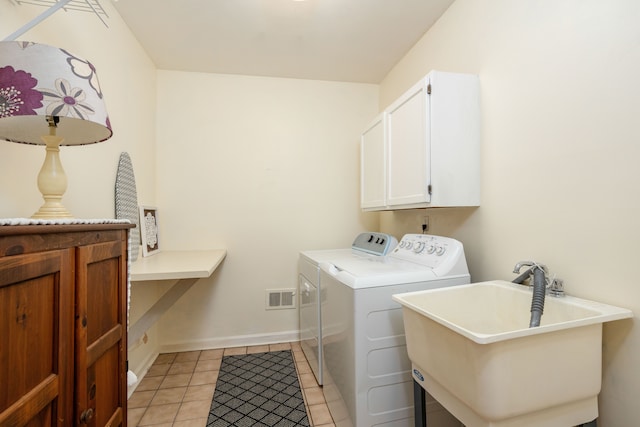 44492 Midway Dr, Novi, MI 48375 - laundry area featuring cabinet space, independent washer and dryer, light tile patterned floors, and baseboards