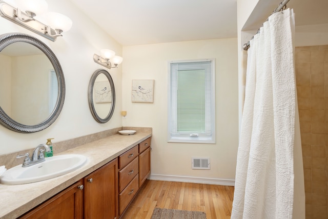44492 Midway Dr, Novi, MI 48375 - bathroom featuring wood finished floors, vanity, baseboards, and a tile shower
