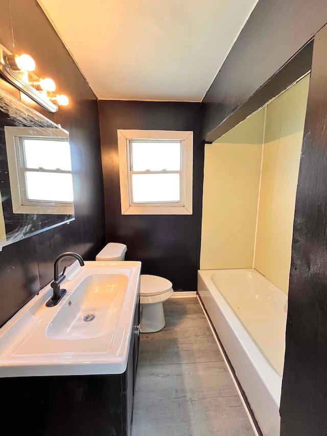 17421 Oakland St, Highland Park, MI 48203 - bathroom featuring toilet, wood finished floors, a bathtub, vanity, and a shower
