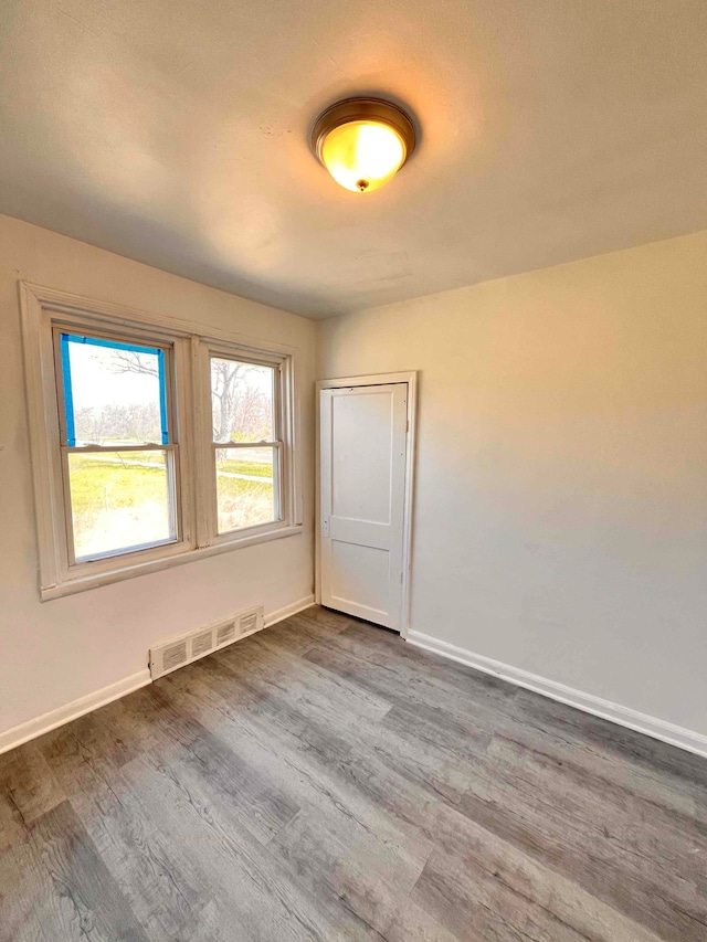 17421 Oakland St, Highland Park, MI 48203 - spare room featuring dark wood-type flooring and baseboards