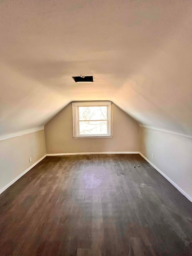 17421 Oakland St, Highland Park, MI 48203 - additional living space featuring baseboards, vaulted ceiling, and dark wood-style floors