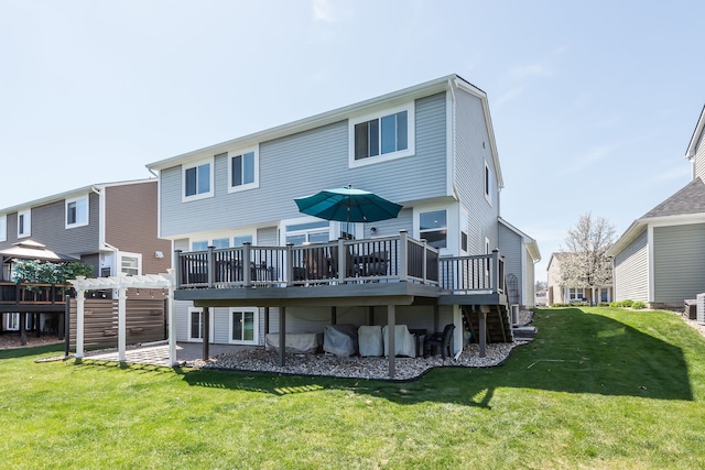 rear view of house featuring a deck, a yard, and a pergola
