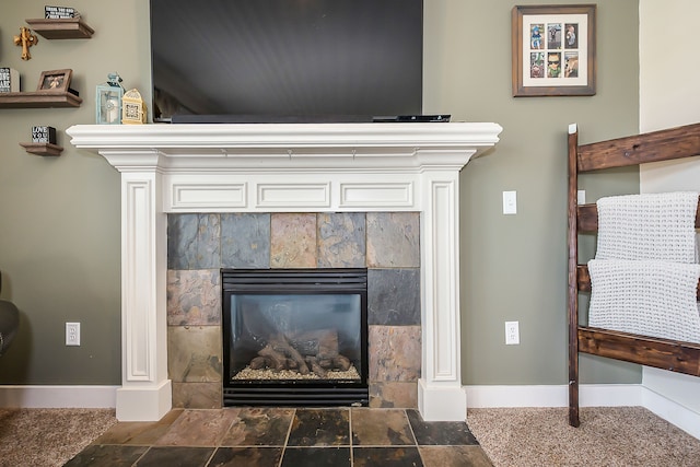 details with a tile fireplace and baseboards