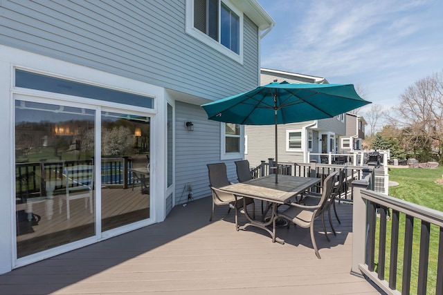 wooden deck featuring outdoor dining area
