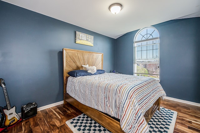 bedroom with wood finished floors and baseboards