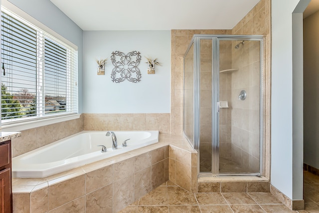full bath with a shower stall, tile patterned flooring, a bath, and vanity