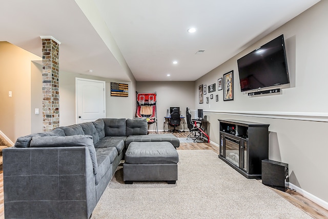 living area featuring recessed lighting, decorative columns, wood finished floors, and baseboards