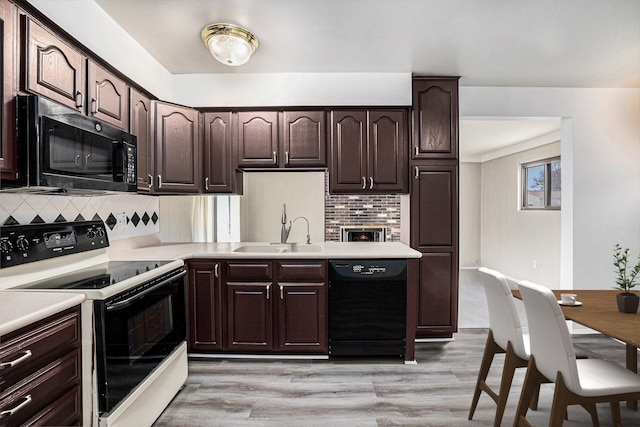 3410 Pasadena Dr, Troy, MI 48083 - kitchen with black dishwasher, decorative backsplash, range with electric stovetop, and a sink