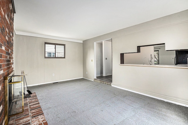 3410 Pasadena Dr, Troy, MI 48083 - unfurnished living room with carpet floors, baseboards, visible vents, and a fireplace