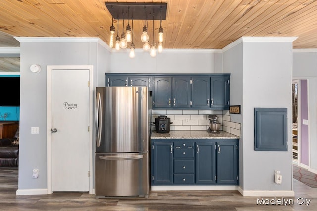 kitchen featuring decorative backsplash, blue cabinets, freestanding refrigerator, wooden ceiling, and ornamental molding